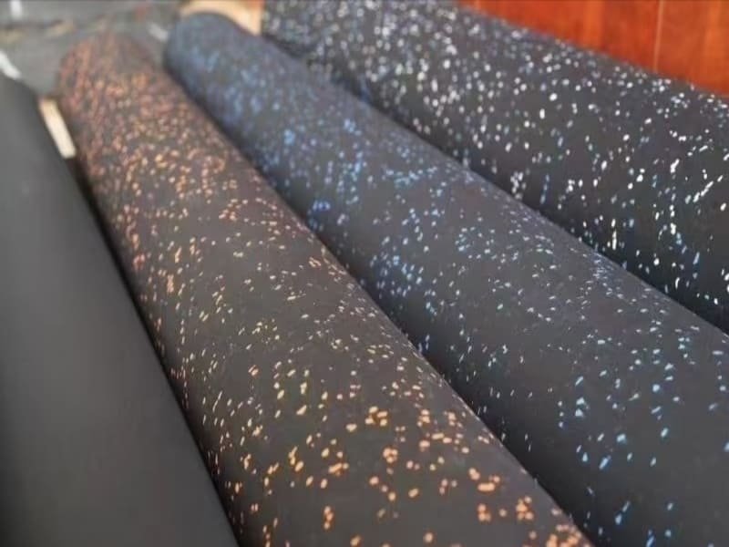 An engineer pointing at a technical data sheet for rubber flooring